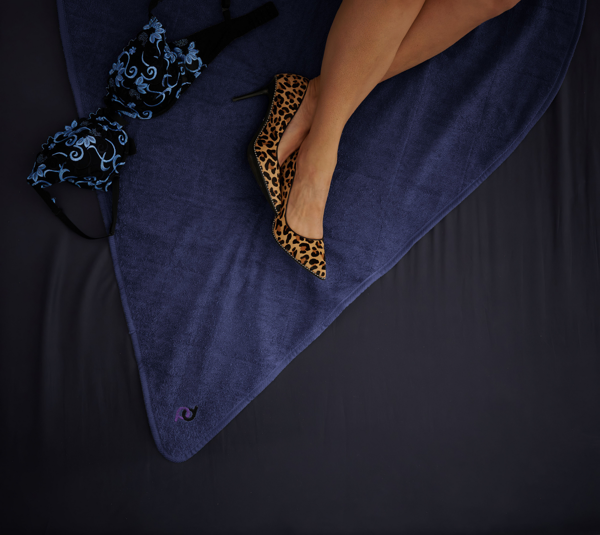 woman in leopard print heels on a navy blue playdrop mat
