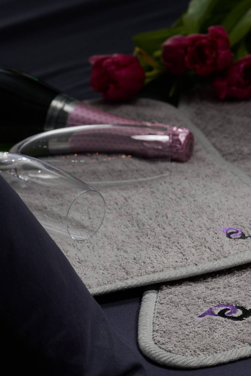 champagne and roses on top of light gray playdrop mat