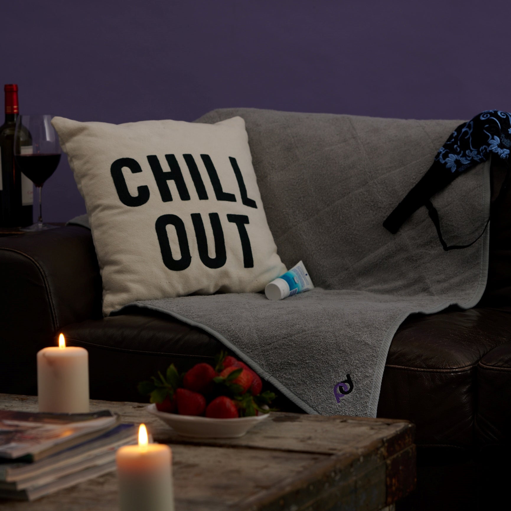 pillow with "chill out" written on it on top of grey sex mat