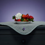 strawberries with whipped cream in bowl above grey playdrop sex mat 