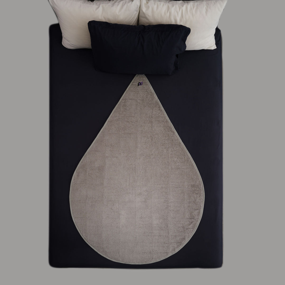 Light grey sex mat displayed on bed